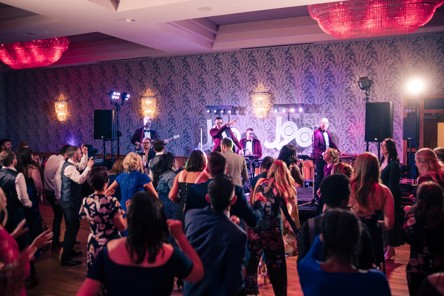 J90 wedding band performing for a packed dancefloor